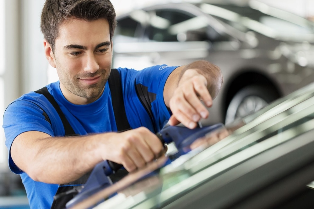  Ford technician replacing a front bumper