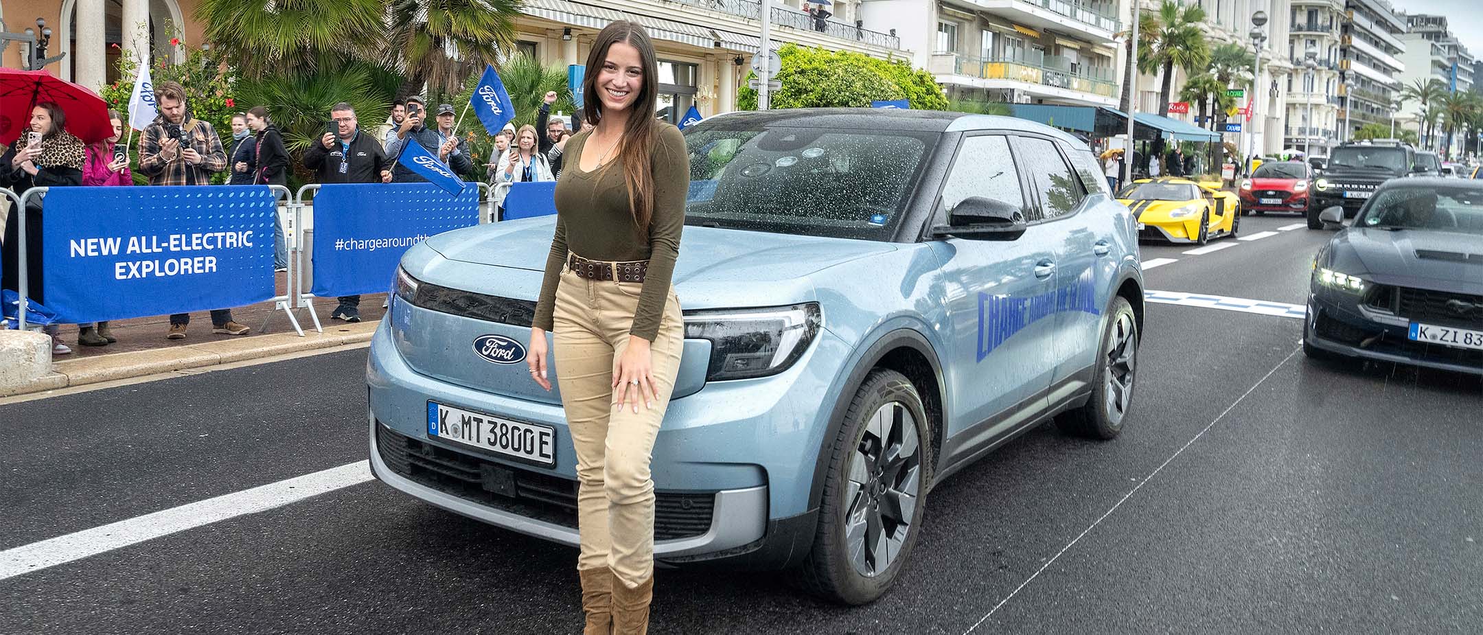 Lexie Alford, aka @LexieLimitless, stood with the Ford Explorer at the Charge Around The Globe finish line.