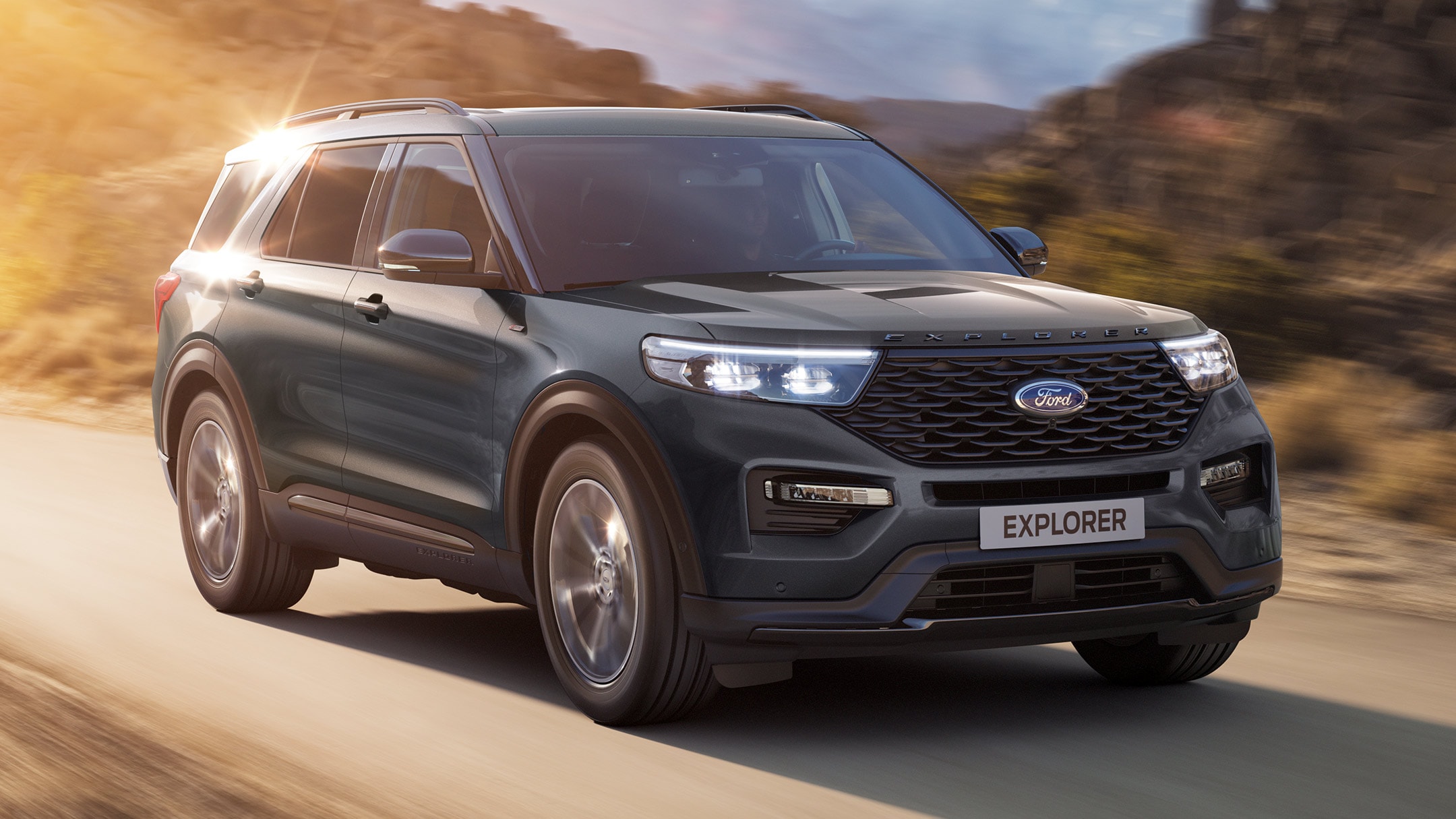 Ford Explorer driving in sun drenched countryside