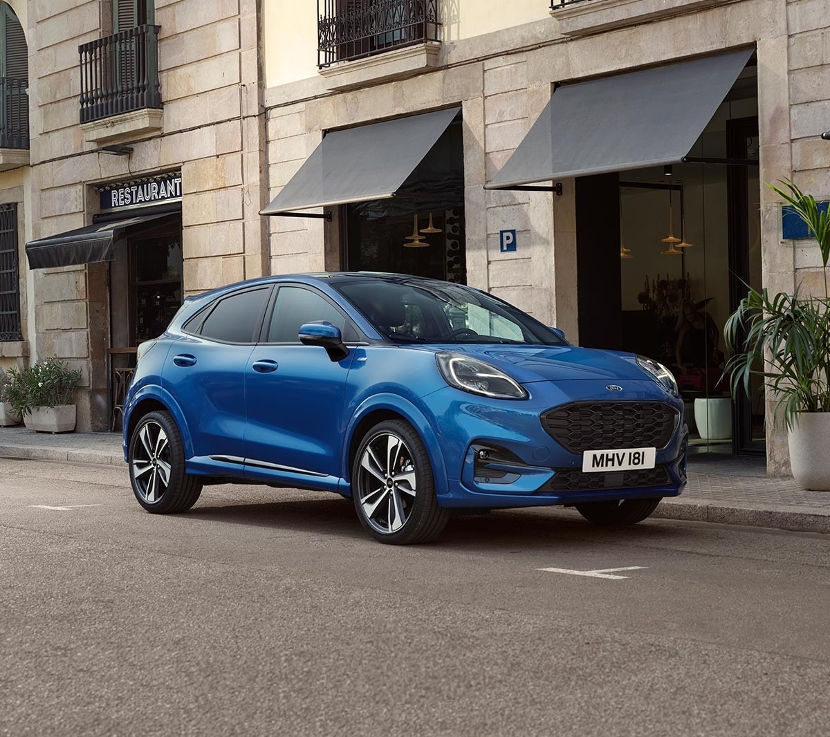 Blue Ford Puma parked outside restaurant