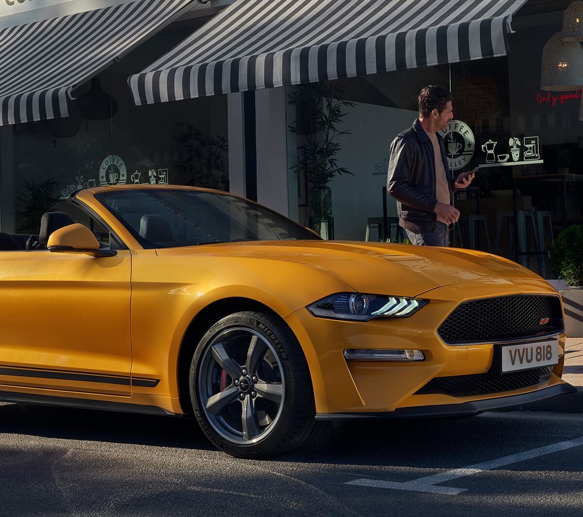 Ford Mustang California Edition parked infront of a coffee shop.