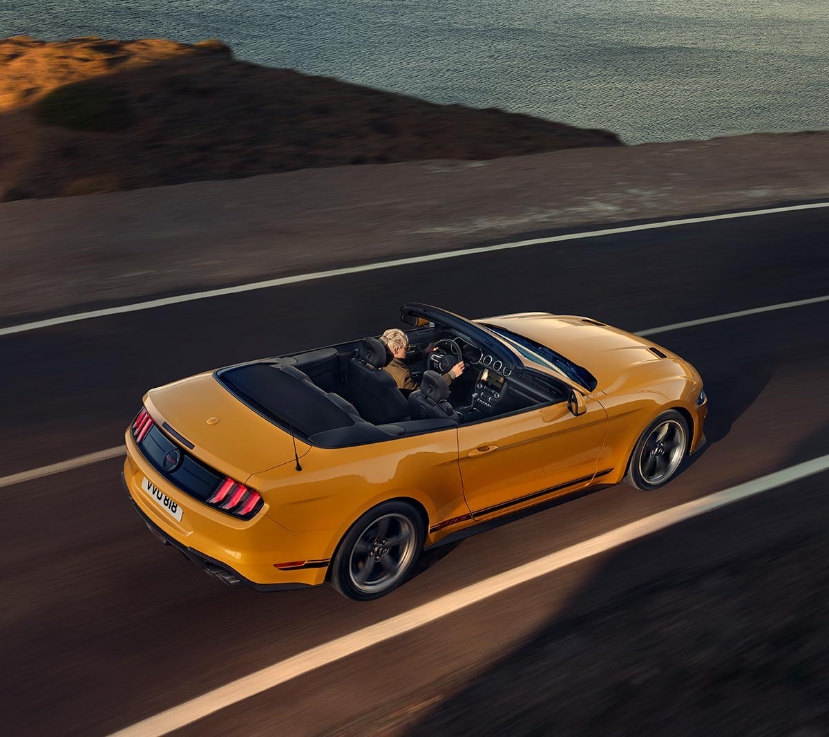 Ford Mustang California Edition driving along a highway viewed from above.