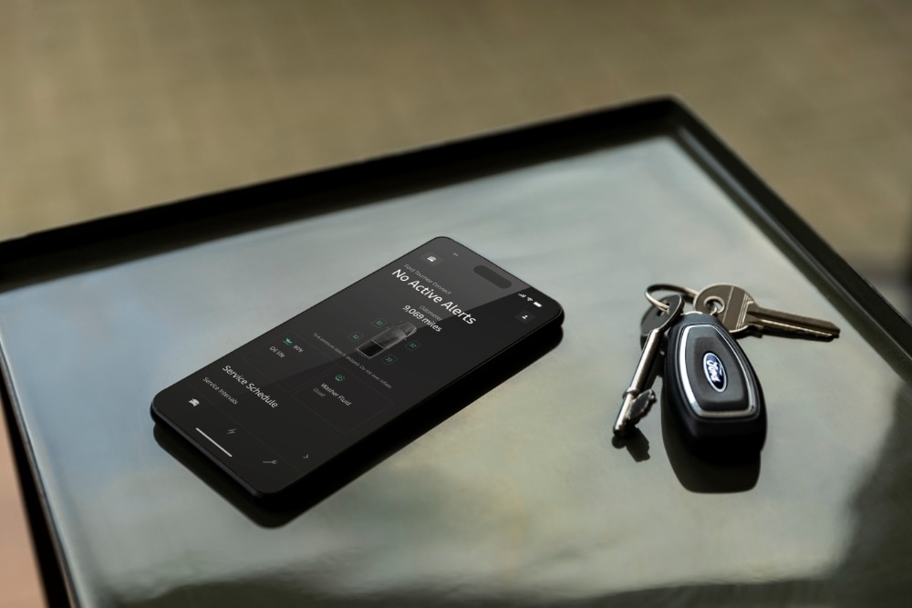 Main tenant un téléphone portable avec l'application Ford