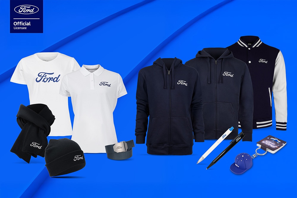 Ford merchandise collection featuring various Ford vehicles in the background with Ford branded umbrella, mugs, and clothing items.