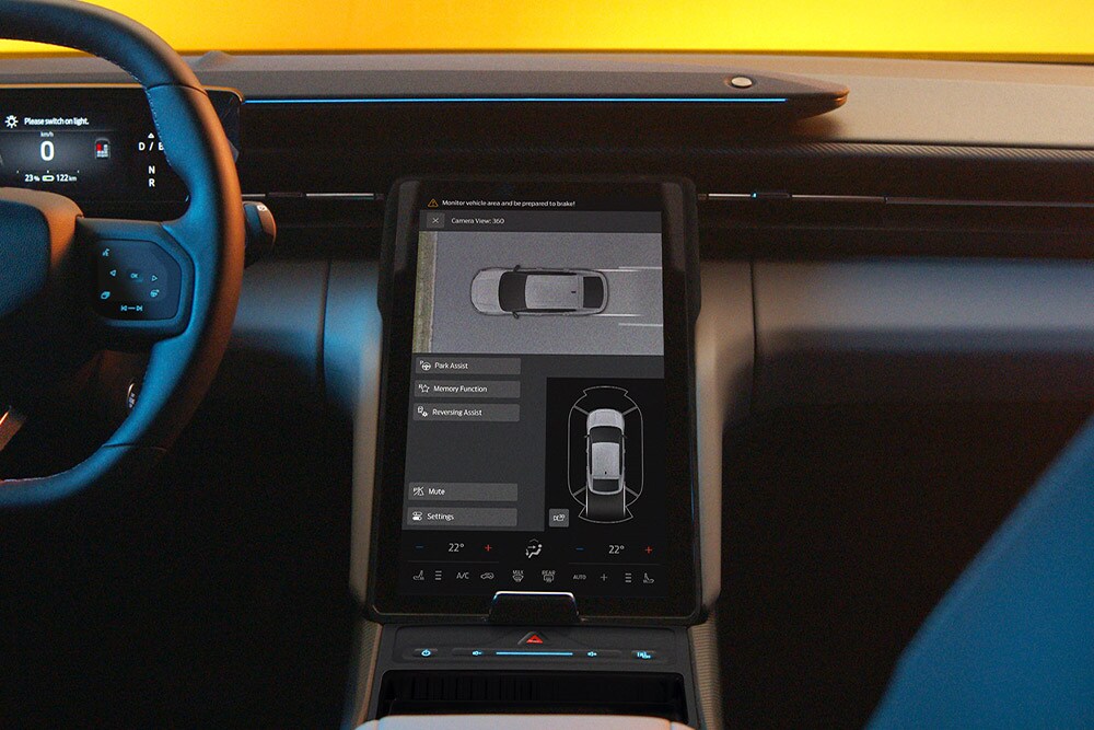 The Ford Capri® touchscreen displaying a split-screen view of the 360° camera system and parking assist guidelines.