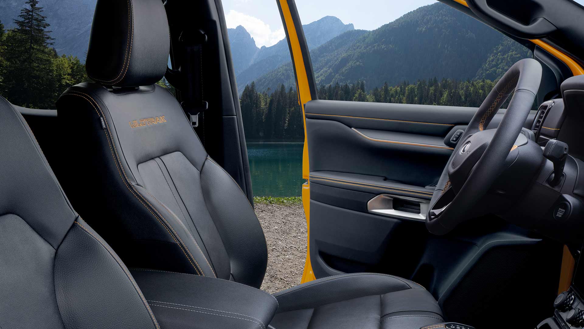 Vue intérieure d'un Ford Ranger Wildtrak avec des sièges en cuir noir et broderie jaune « Wildtrak ».