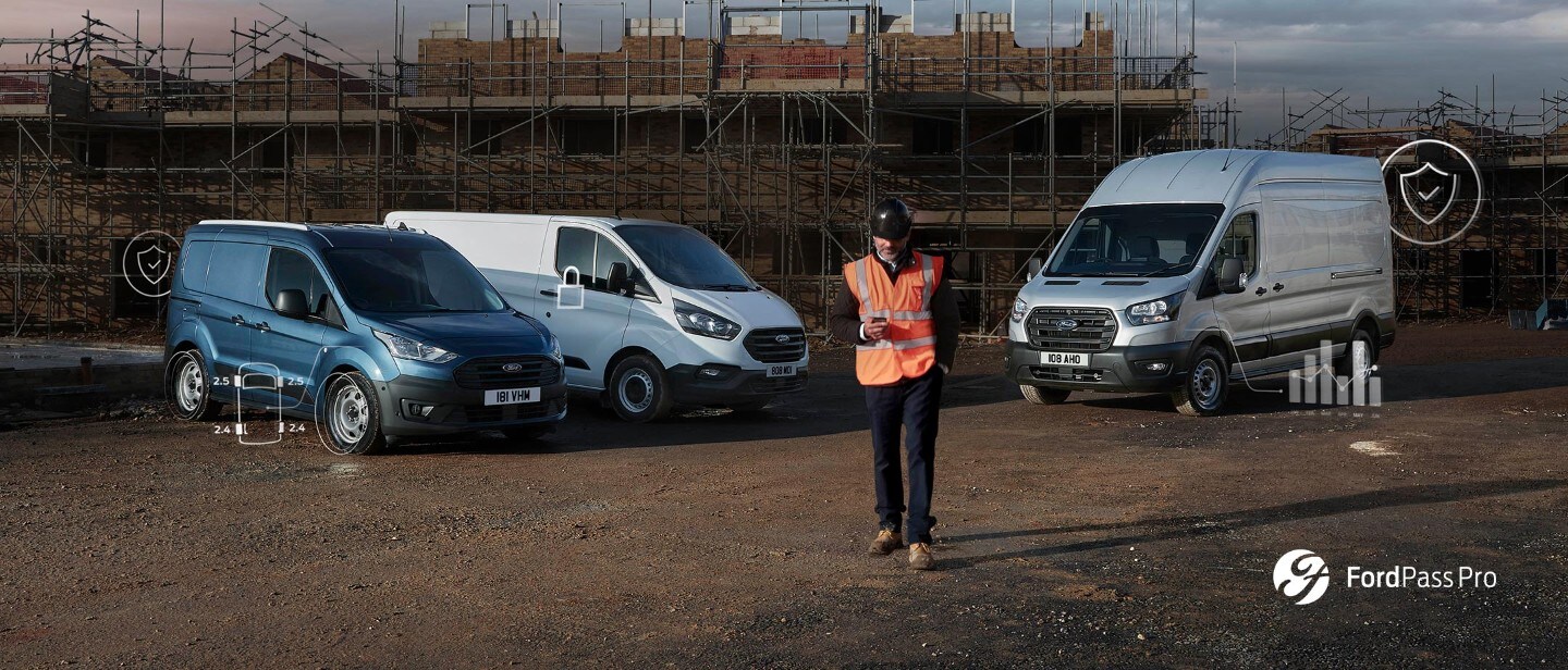 Man looking at his smartphone at a building site with Ford Commercial Vehicles in the background
