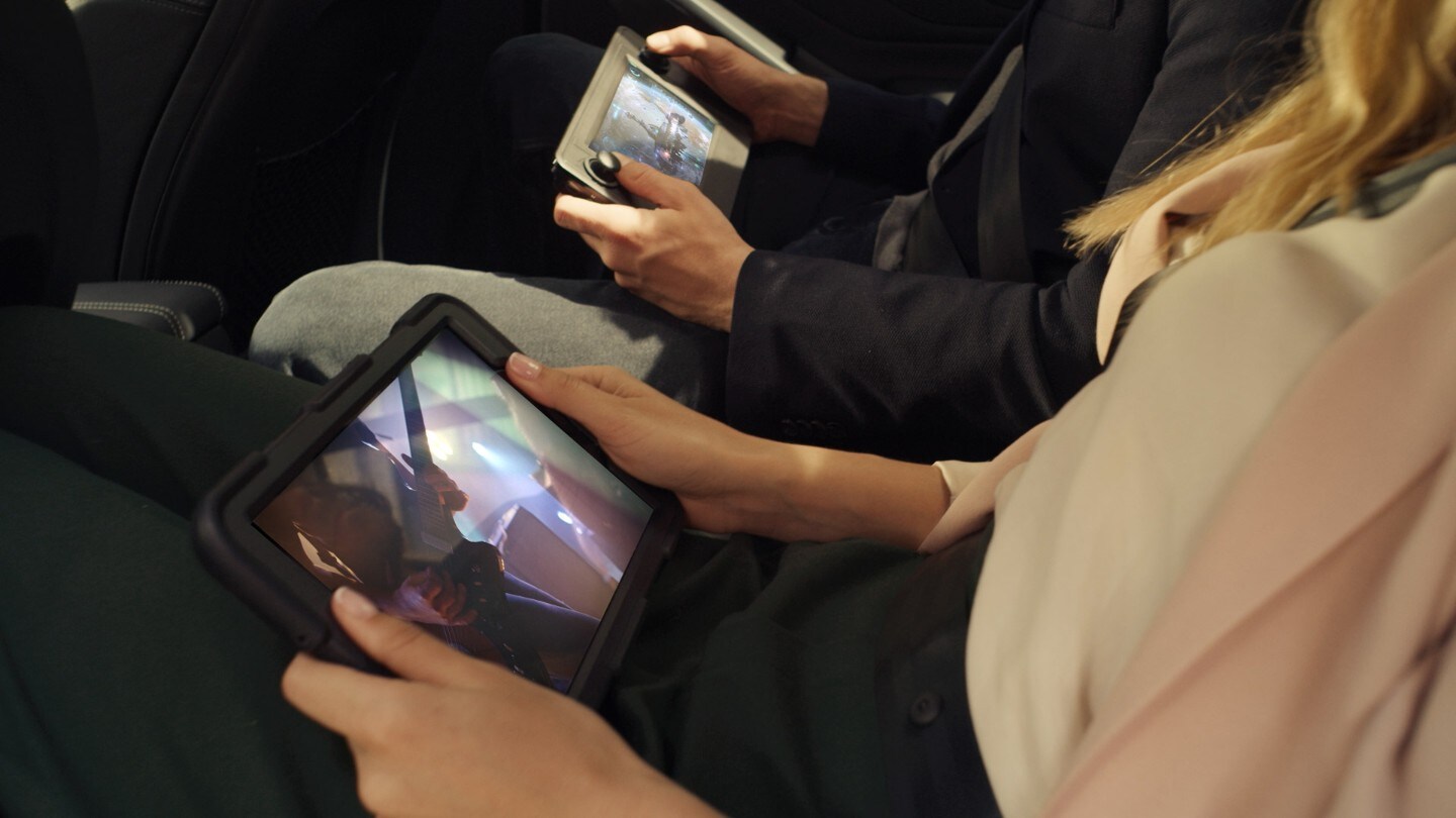 People holding tablets in Ford car