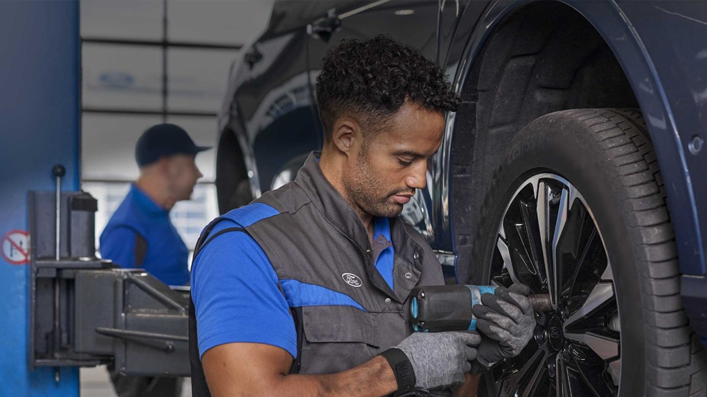 Ford mechanic inspecting a car