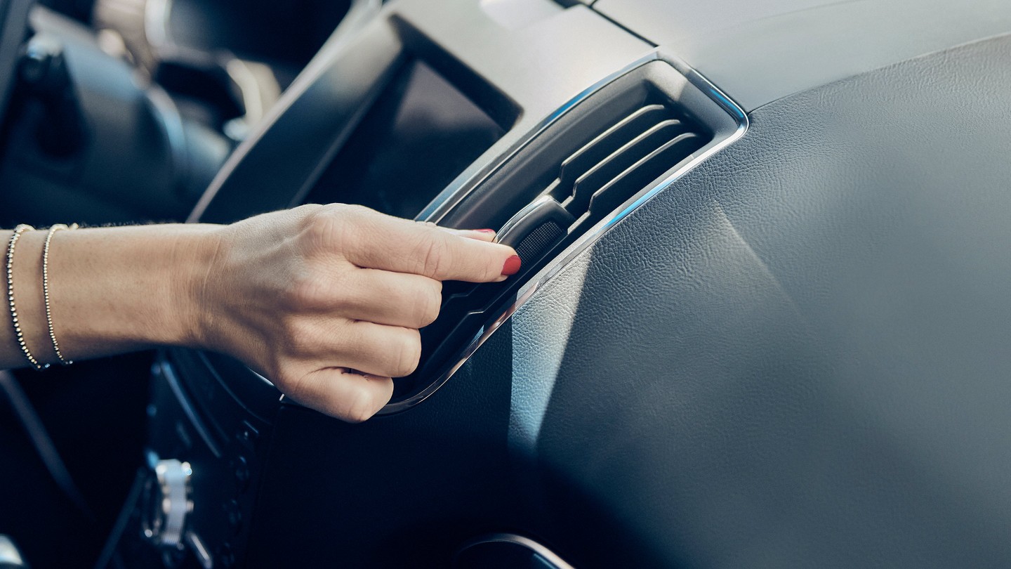Hand adjusting ventilation in car